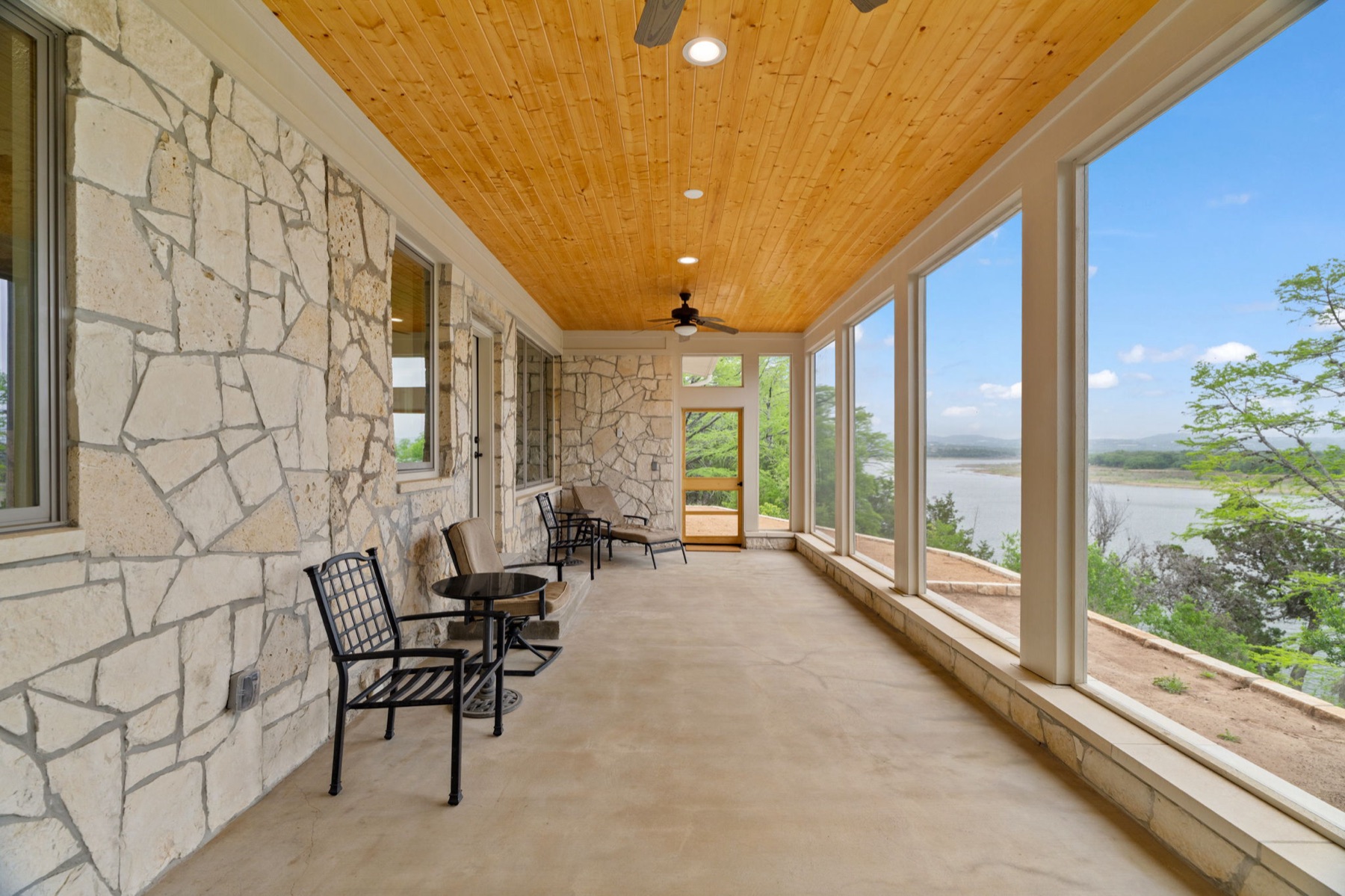 Covered stone veranda opening to Lake Travis