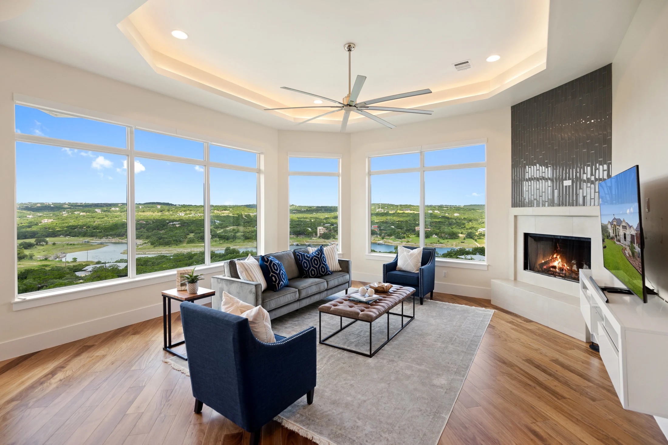 Bright living room with fireplace and broad landscape views
