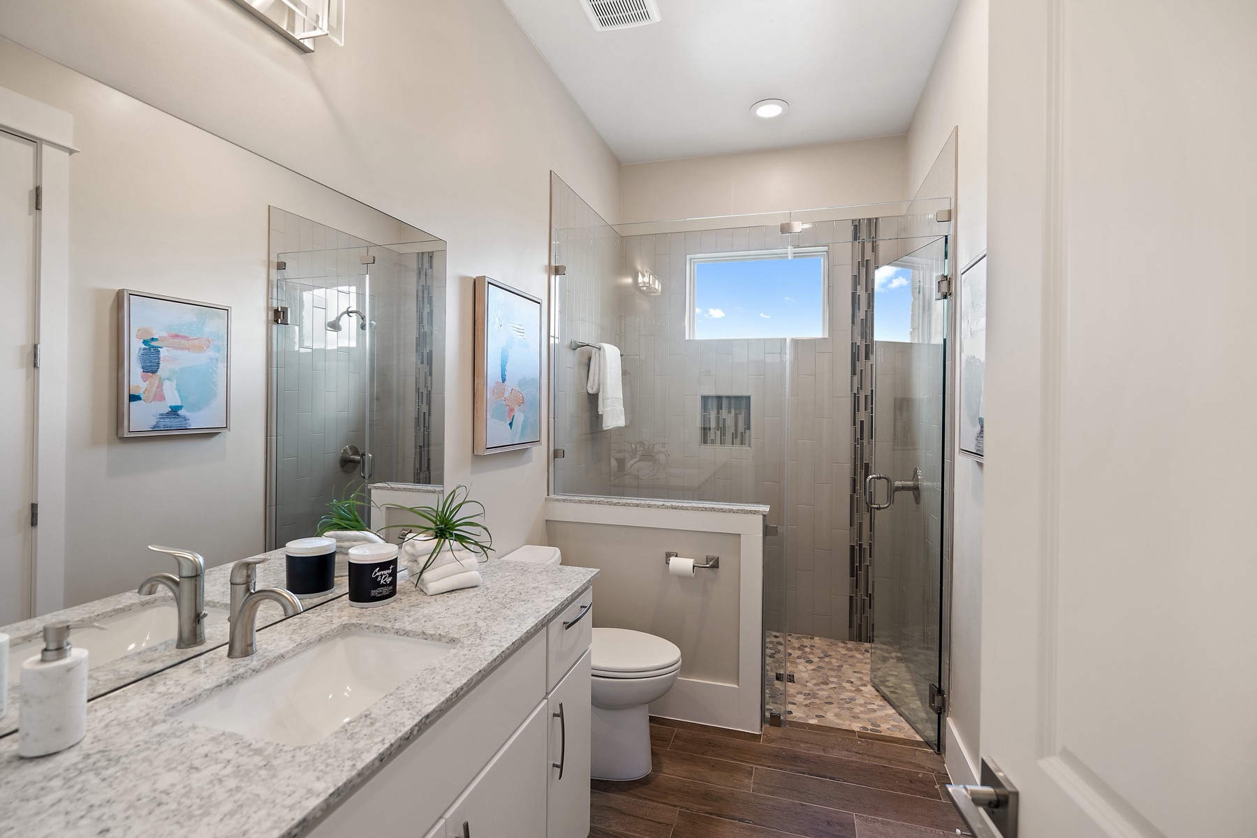 Calm custom bathroom with a walk-in shower and natural light