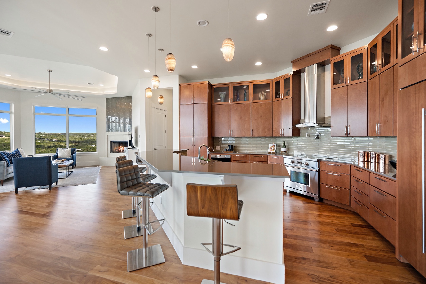 Warm walnut kitchen opening into a Hill Country living space