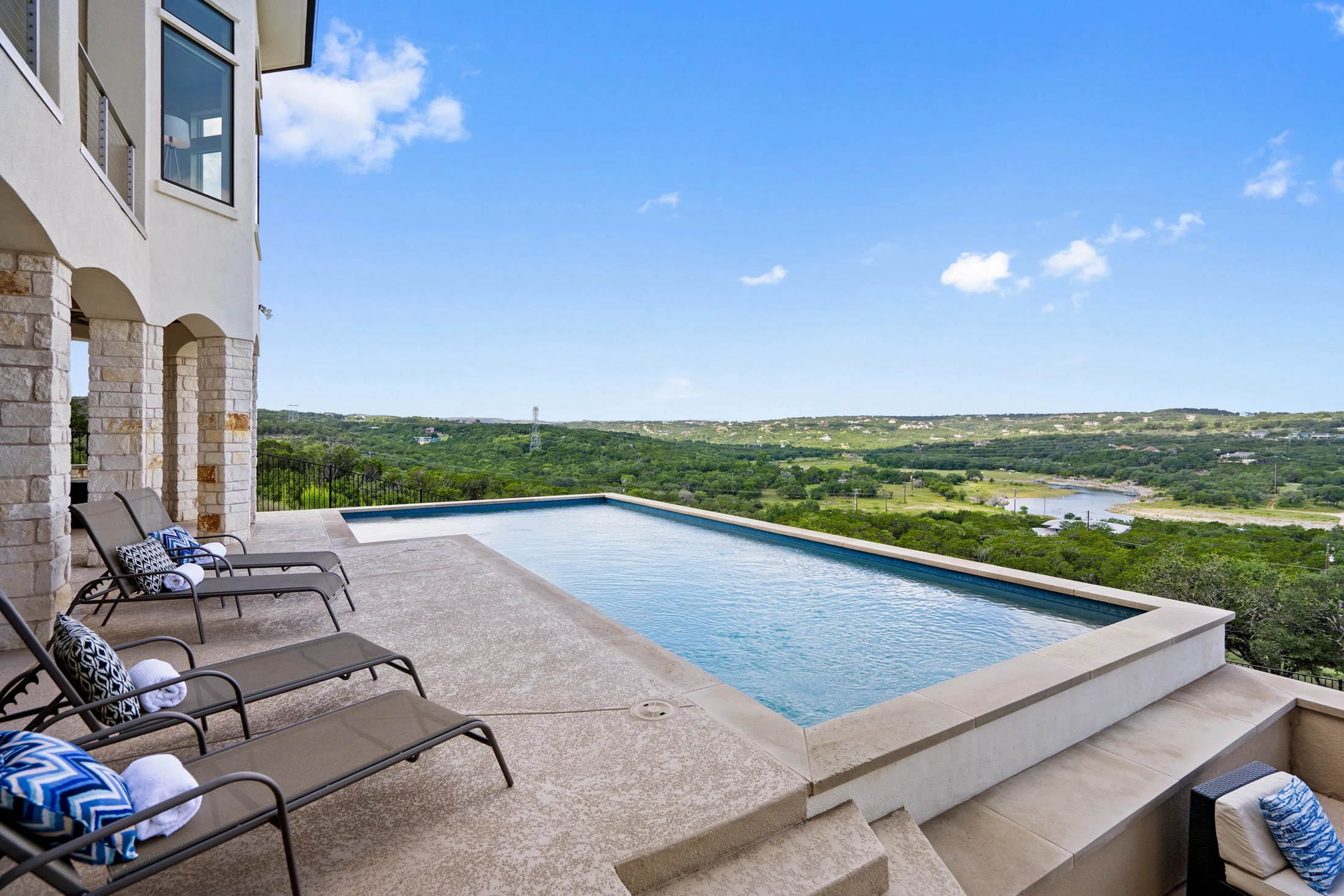 Infinity pool overlooking rolling green Hill Country